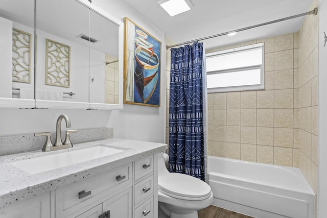 full bathroom featuring hardwood / wood-style flooring, vanity, toilet, and shower / bath combo