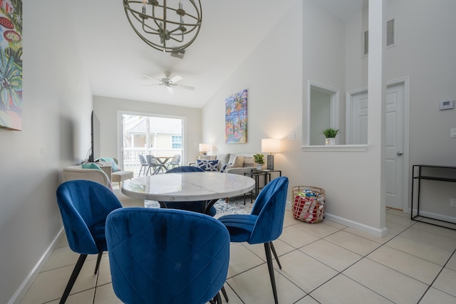 tiled dining space with high vaulted ceiling and ceiling fan