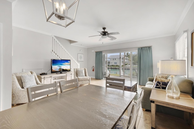 dining space with ceiling fan with notable chandelier and ornamental molding