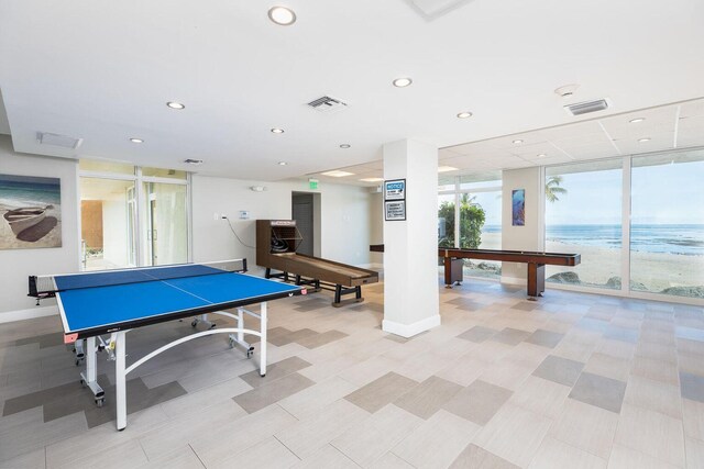 playroom featuring a water view and floor to ceiling windows