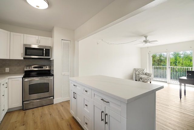 kitchen with white cabinetry, tasteful backsplash, appliances with stainless steel finishes, ceiling fan, and light hardwood / wood-style floors