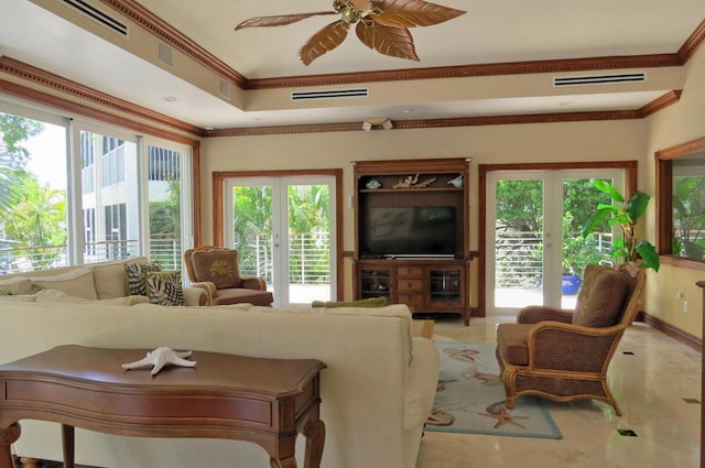 living room featuring visible vents, crown molding, and ceiling fan