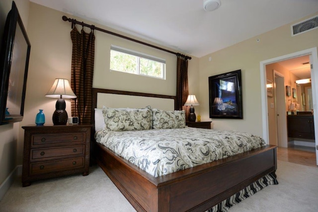 bedroom featuring light carpet and visible vents