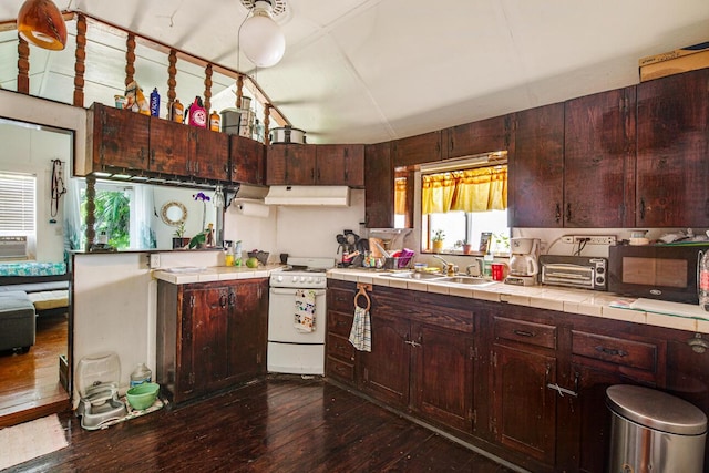 901 Eisenhower Dr, Key West, FL 33040 - kitchen with white range oven, tile countertops, under cabinet range hood, dark wood-type flooring, and black microwave