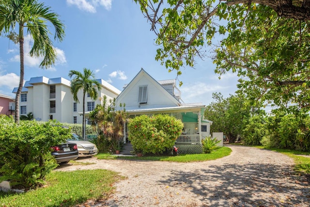 901 Eisenhower Dr, Key West, FL 33040 - view of front facade featuring a porch and dirt driveway