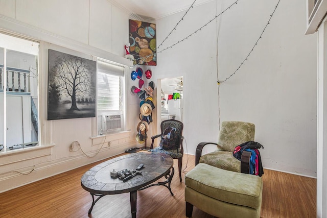 living area with hardwood / wood-style flooring and cooling unit