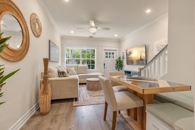 living room with ornamental molding, hardwood / wood-style floors, and ceiling fan