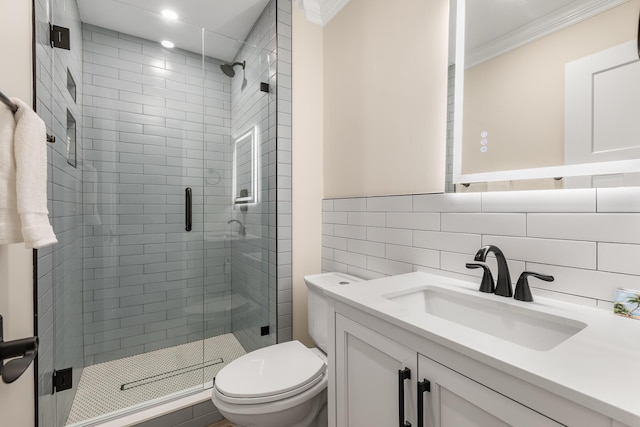 bathroom with crown molding, vanity, toilet, and an enclosed shower