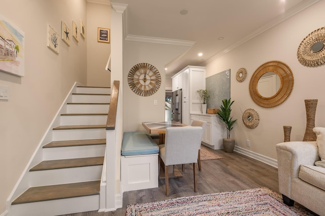 dining room featuring dark wood-type flooring and crown molding