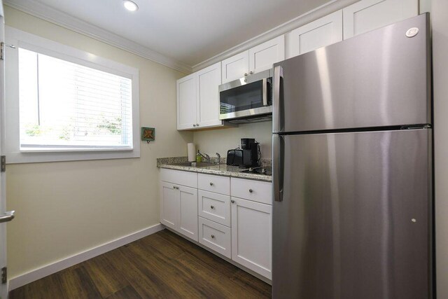 156 Marine Ave, Tavernier, FL 33070 - kitchen featuring ornamental molding, white cabinetry, dark wood-type flooring, appliances with stainless steel finishes, and a sink