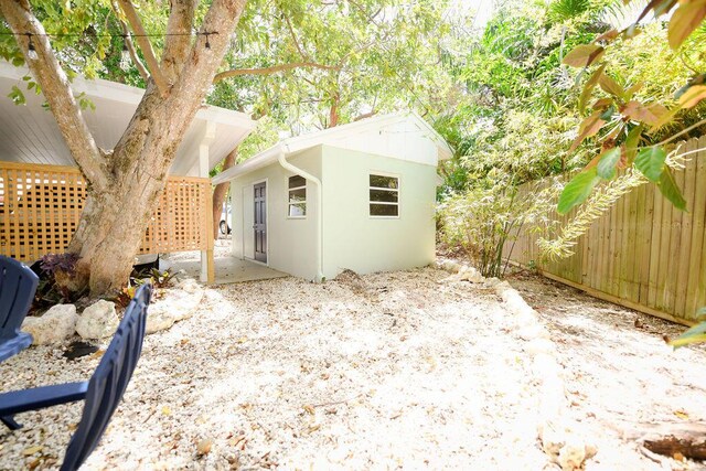 156 Marine Ave, Tavernier, FL 33070 - view of property exterior featuring a fenced backyard, an outdoor structure, and stucco siding