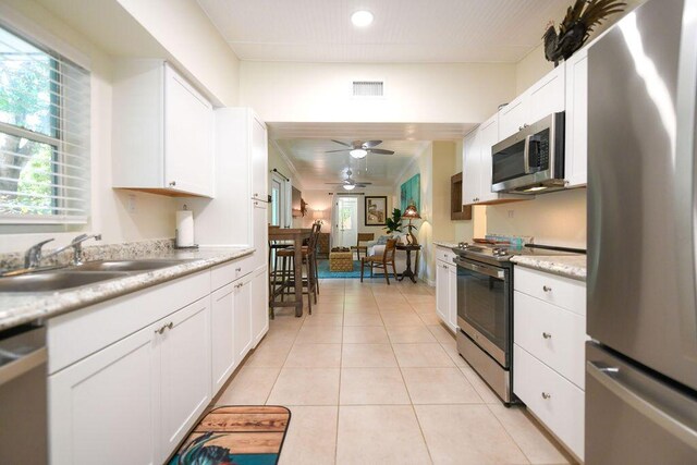 156 Marine Ave, Tavernier, FL 33070 - kitchen with light tile patterned floors, a sink, ceiling fan, appliances with stainless steel finishes, and light countertops