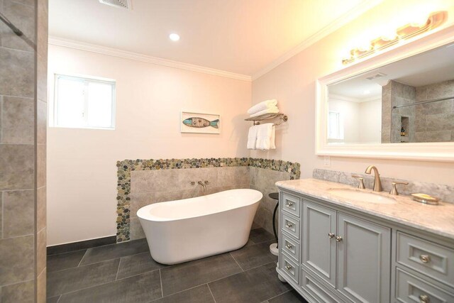 156 Marine Ave, Tavernier, FL 33070 - bathroom with crown molding, vanity, tile walls, a freestanding bath, and tile patterned floors