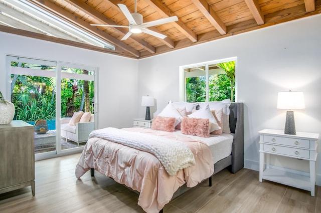 bedroom with multiple windows, wooden ceiling, vaulted ceiling with beams, and access to exterior