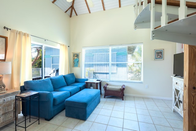 living area featuring plenty of natural light, wooden ceiling, baseboards, and light tile patterned flooring