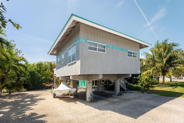 exterior space with driveway, stairway, and a carport