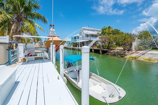 dock area with boat lift and a water view