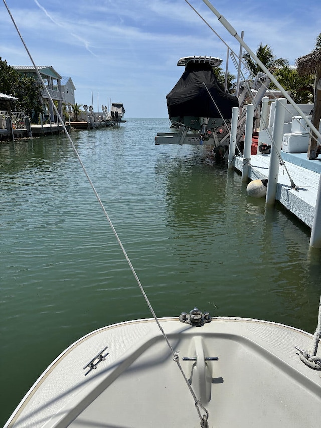 view of dock with boat lift and a water view