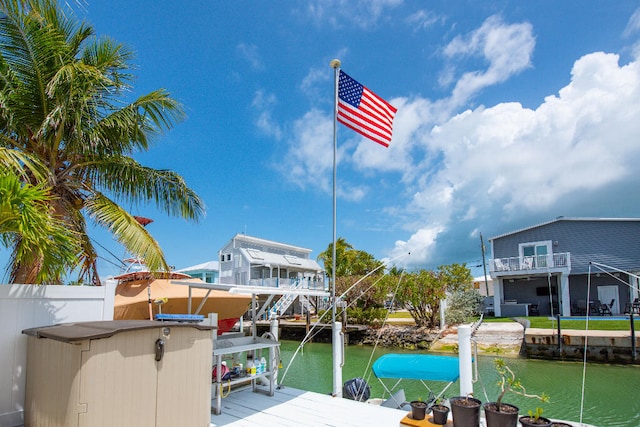 dock area with a water view and boat lift