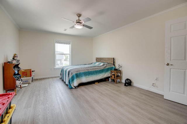bedroom with baseboards, ornamental molding, and wood finished floors