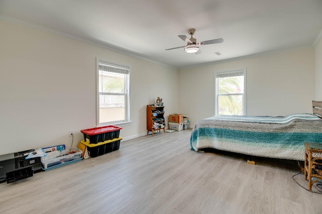 bedroom featuring crown molding, wood finished floors, and multiple windows