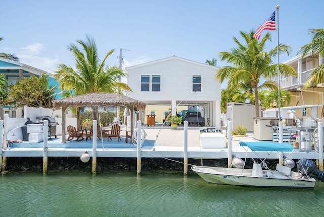 view of dock with a water view and a gazebo