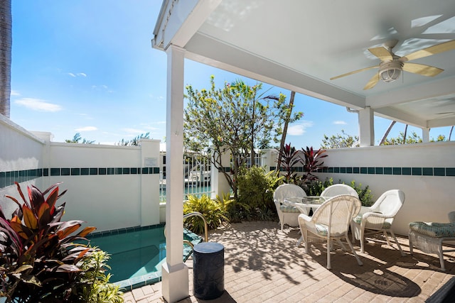 view of patio / terrace featuring a ceiling fan, outdoor dining space, and fence