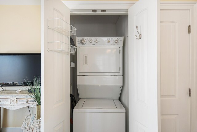 laundry area with stacked washer and clothes dryer and laundry area