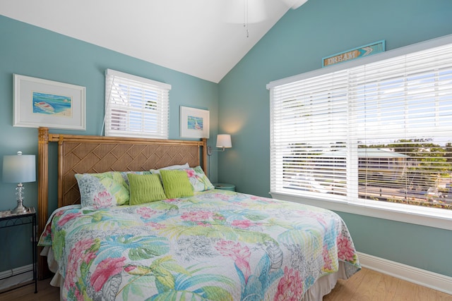 bedroom featuring vaulted ceiling, baseboards, and wood finished floors