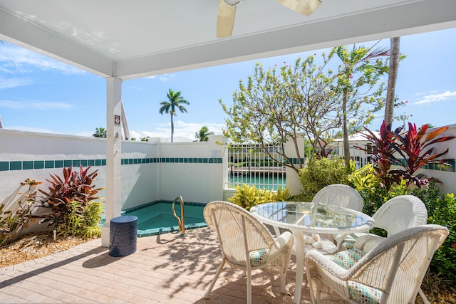 view of patio with a fenced backyard, a ceiling fan, and outdoor dining space