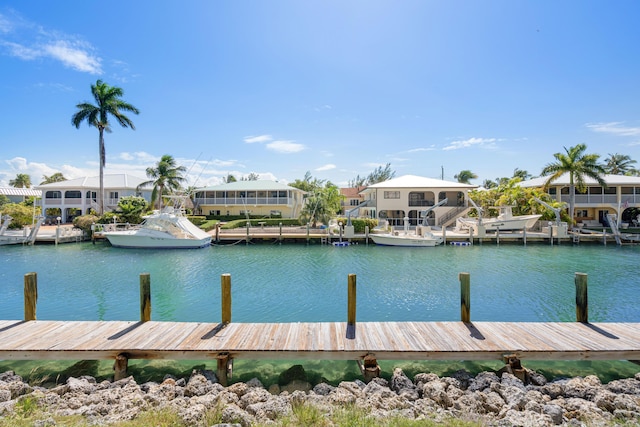 view of dock featuring a residential view and a water view