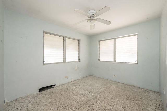 unfurnished room with a wealth of natural light and ceiling fan