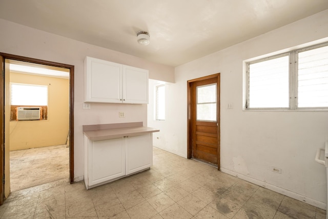 kitchen with white cabinetry, cooling unit, and a wealth of natural light