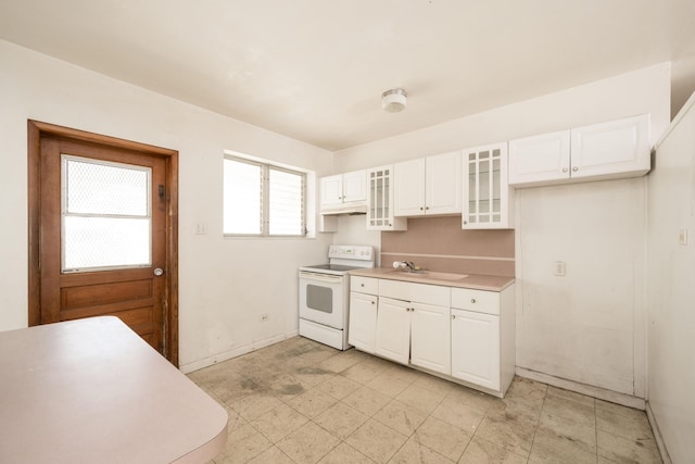 kitchen with white range with electric cooktop, sink, and white cabinets