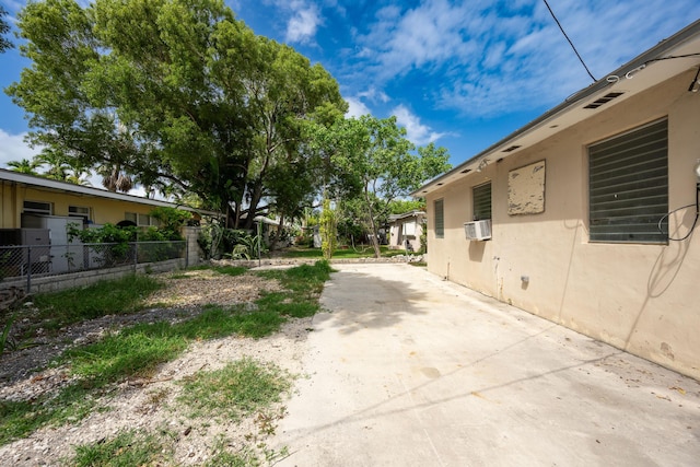 view of yard featuring cooling unit and a patio