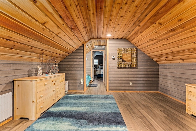 additional living space featuring hardwood / wood-style flooring, wooden ceiling, and wooden walls