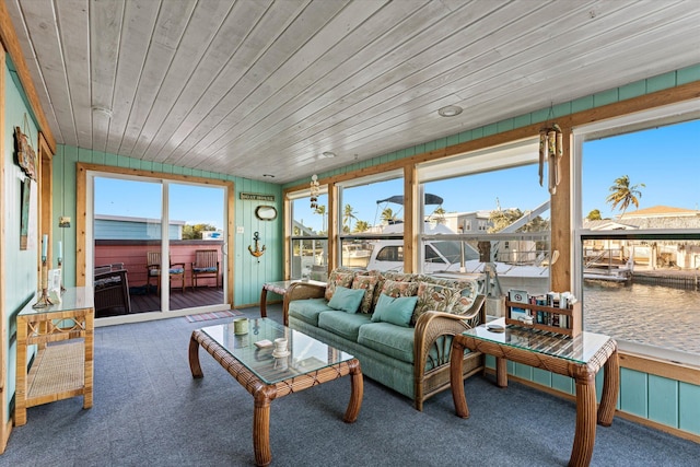 sunroom with a water view and wood ceiling