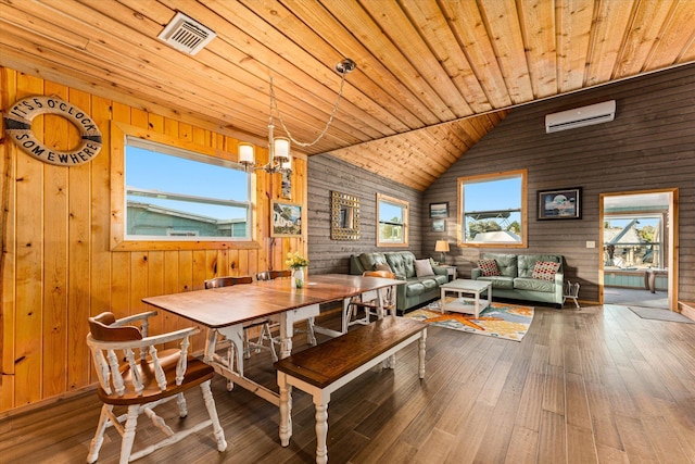 dining area with lofted ceiling, wood ceiling, an inviting chandelier, a wall mounted air conditioner, and hardwood / wood-style flooring