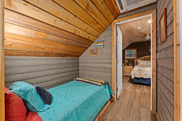 bedroom featuring wood-type flooring, vaulted ceiling, wooden ceiling, and wood walls