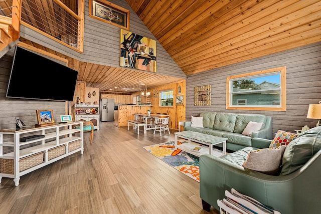 living room featuring wood-type flooring, wooden walls, high vaulted ceiling, and wooden ceiling