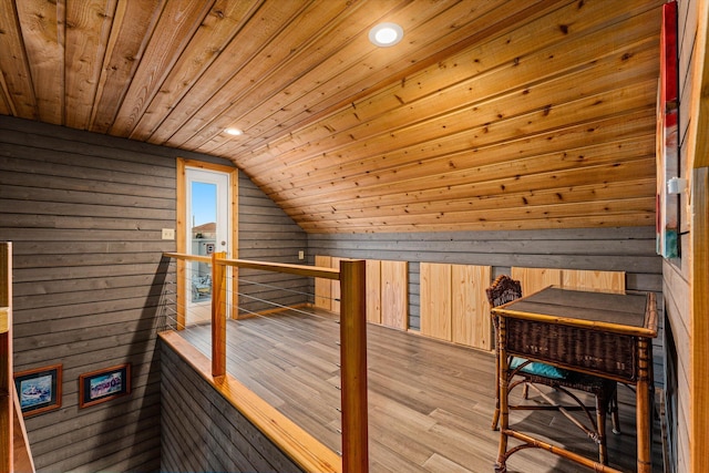 additional living space with vaulted ceiling, wooden ceiling, wooden walls, and light wood-type flooring