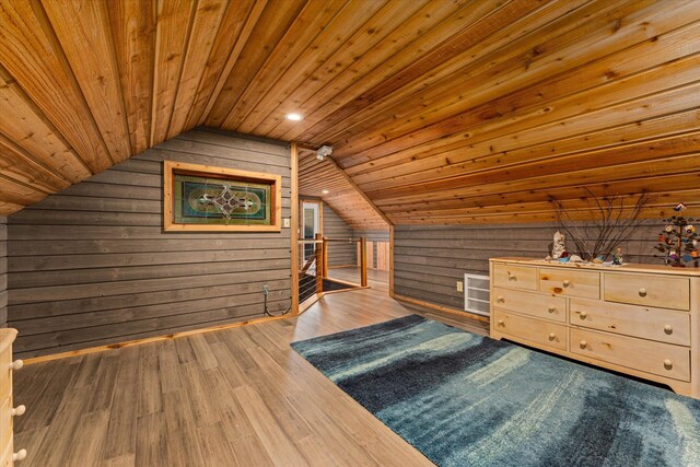 bonus room featuring wood-type flooring, lofted ceiling, wooden ceiling, and wood walls