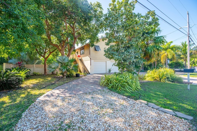 obstructed view of property with a garage and a front yard