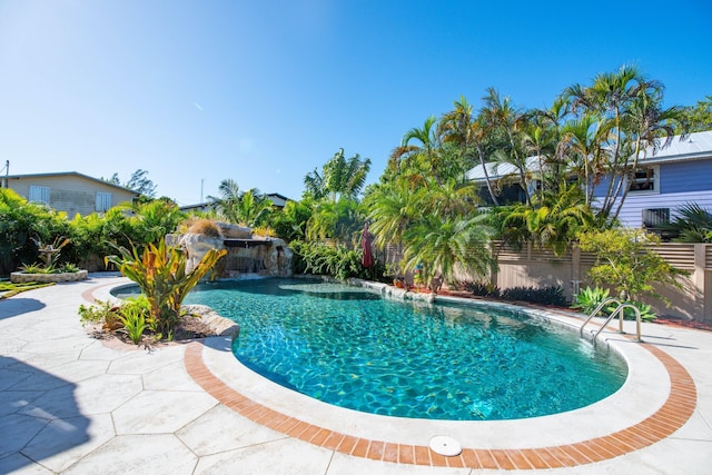 view of pool with a patio area and pool water feature