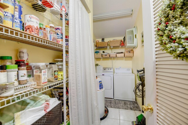 laundry room with separate washer and dryer and light tile patterned floors