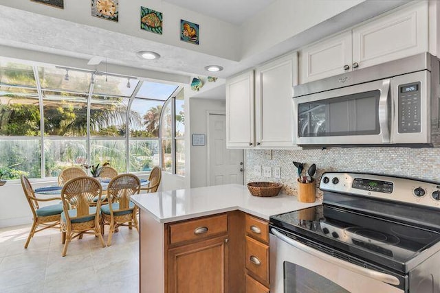 140 Aregood Ln Unit C2, Islamorada, FL 33036 - kitchen featuring stainless steel appliances, light countertops, backsplash, and plenty of natural light