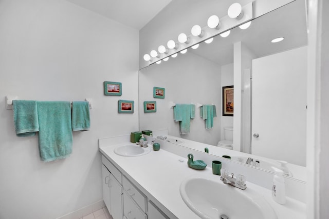 bathroom with vanity, tile patterned flooring, and toilet