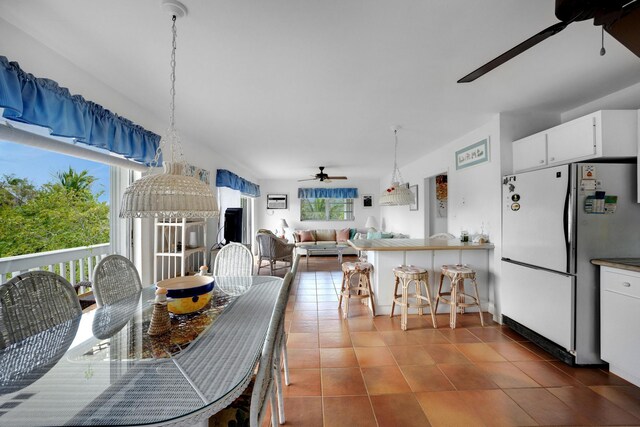 tiled dining room with ceiling fan