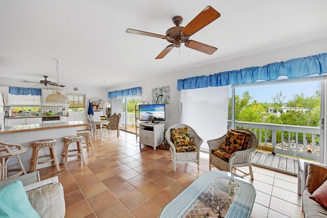 living room with ceiling fan and light tile patterned floors