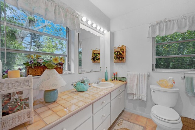 bathroom featuring vanity, toilet, and tile patterned flooring